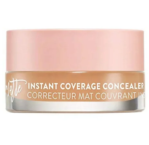Cosmetic jar with pink lid labeled 'Instant Coverage Concealer'.